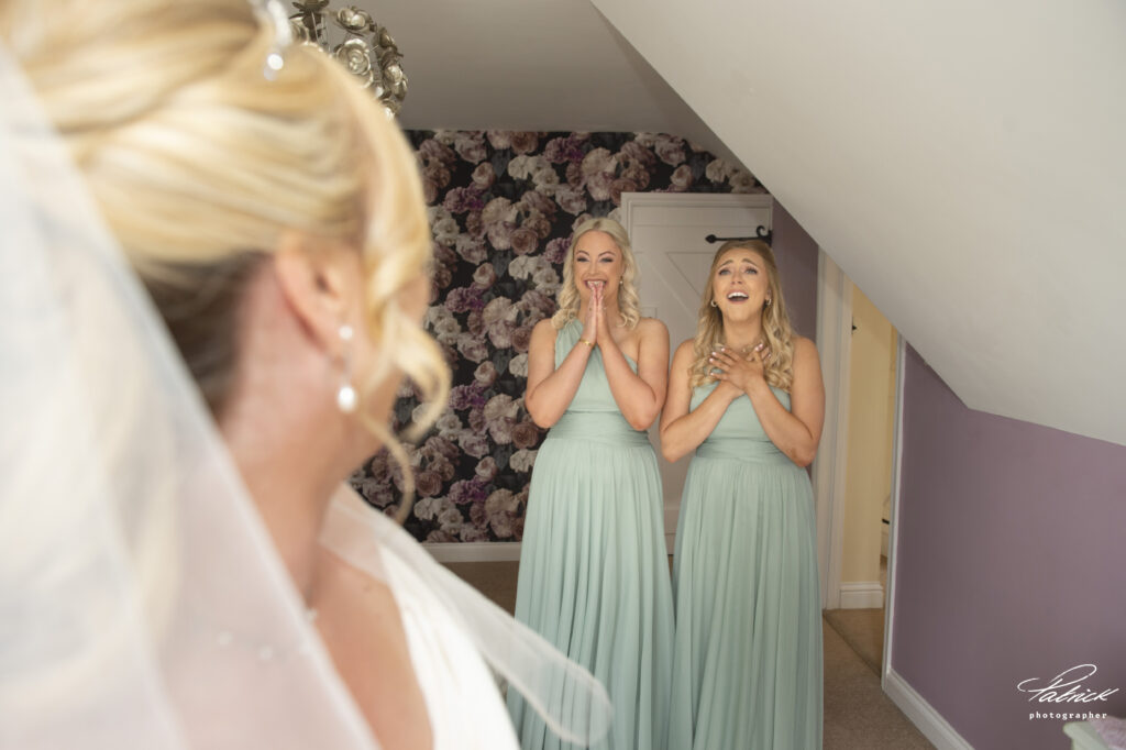 emotional bridesmaids, bride. bridesmaids clasping hands