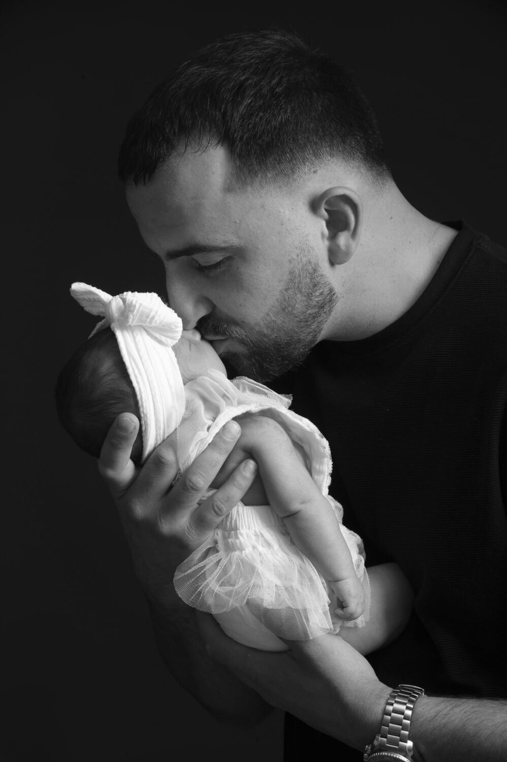 black and white image, dad kissing newborn, dad and daughter, 