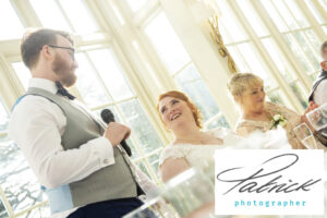 groom speech, bride smiles, red hair, mother inlaw in background