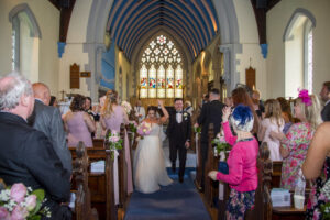 bride, groom, altar, walking aisle, cheering, people clapping