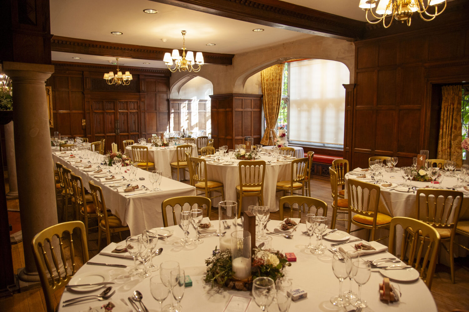 lanwades hall, great hall, wedding breakfast, tables, cutlery, floral arrangements, candles, atmospheric, white linen,