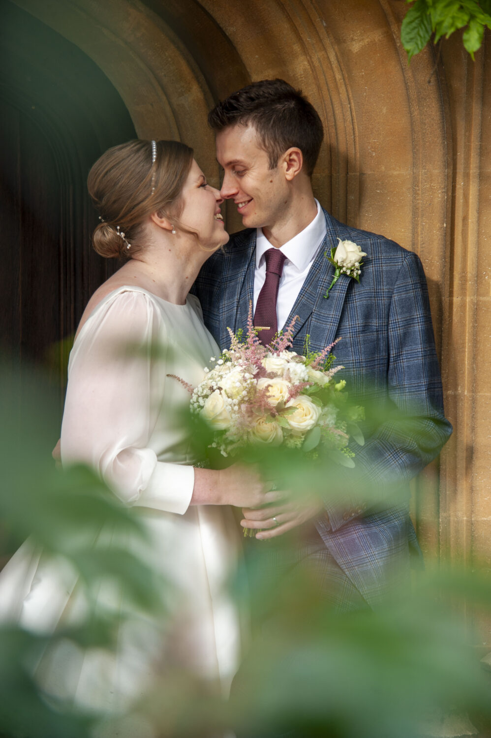 lanwadeshall, arch way, bride and groom background, flowers foreground, oak door