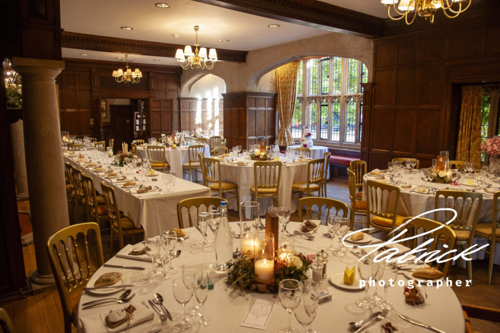 lanwadeshall, great hall, candles, wedding breakfast, atmospheric, tables, chairs, bay window, cutlery, decoration, floristry, top table, round table,