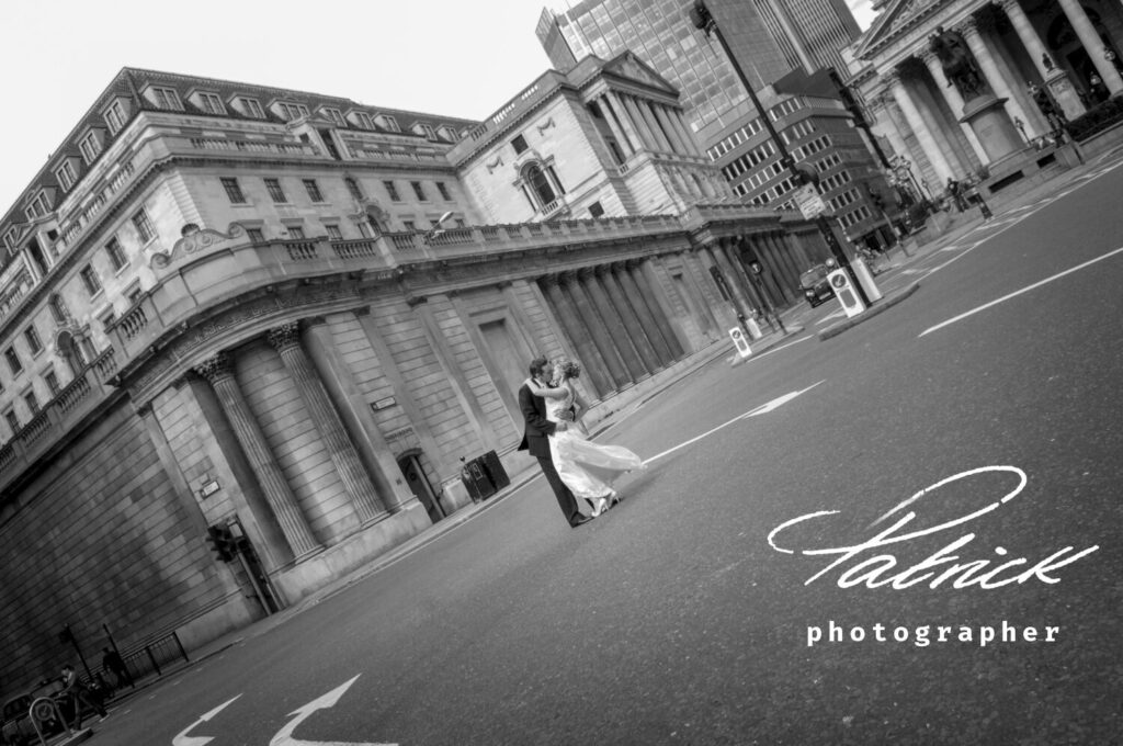 London image. bride and groom embrace in the middle of the road at Bank