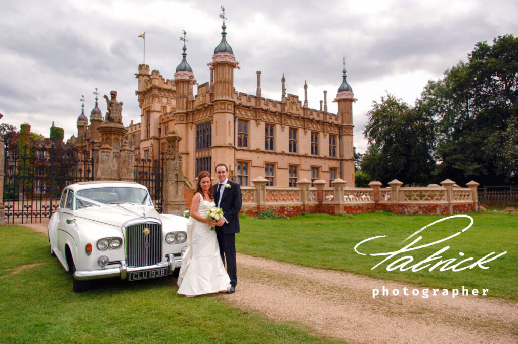 knebworth barn wedding venue, gates, rolls royce and bride and groom