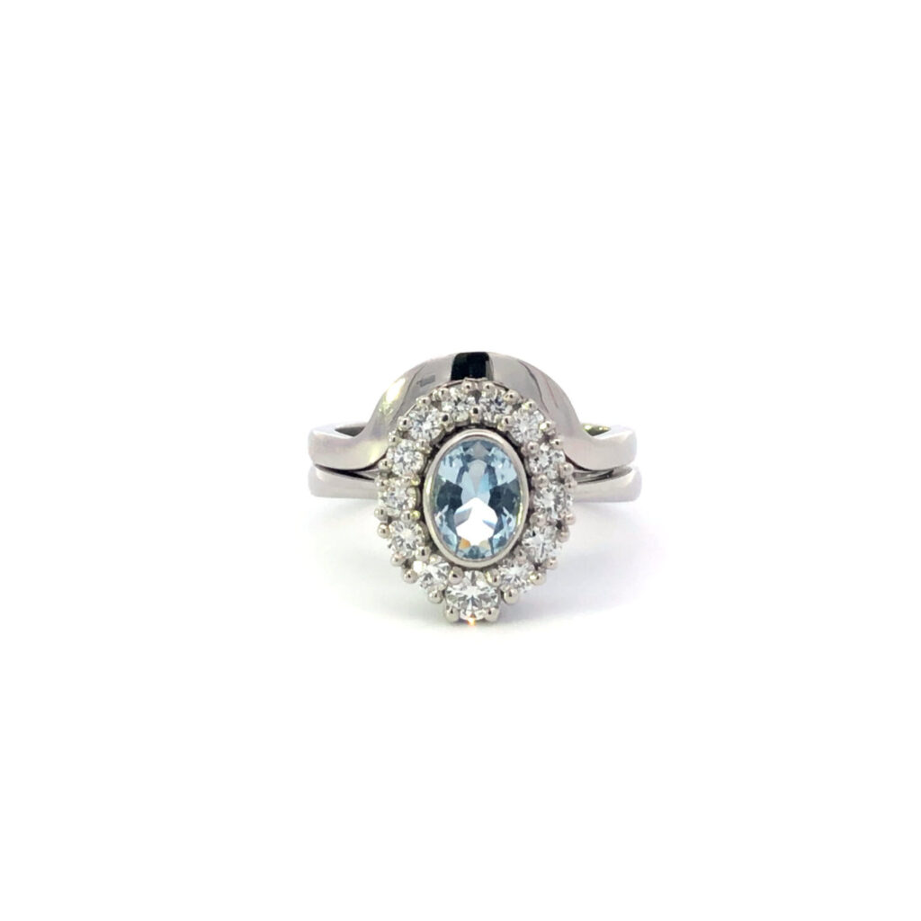 Cluster halo oval blue topaz rubover shaped wedding ring claw