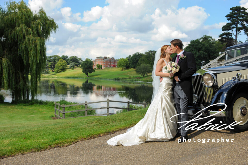 bride and groom with brocket hall in the distance