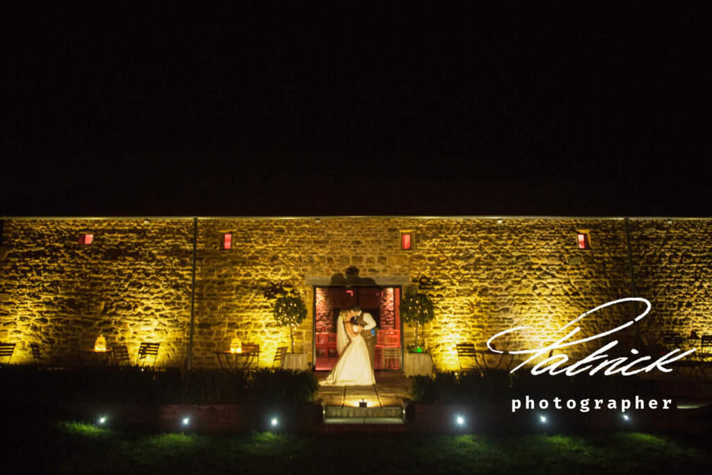 Dodford Manor, soft focus, bride and groom kiss. night atmospheric shot