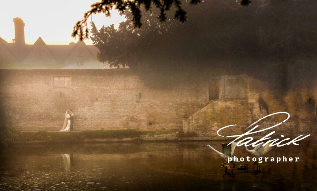 misty atmospheric sepia toned image. jewish bride and groom embrace in front of high brick wall behind a pond. Pair of flying geese swans land on the water