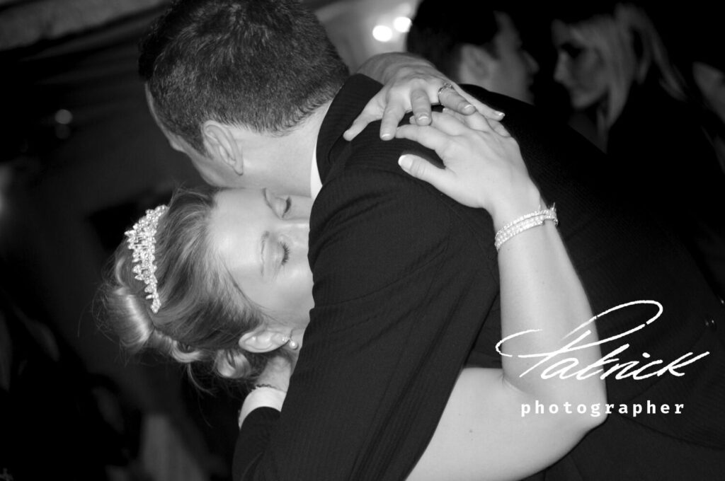 groom hugs his bride, black and white close up,