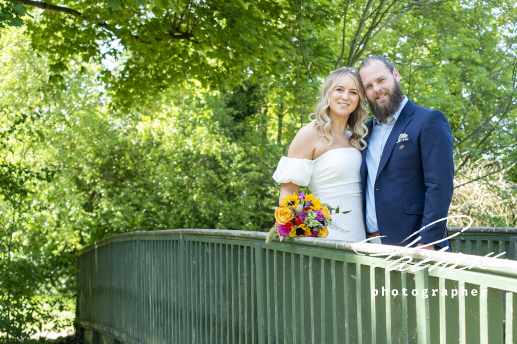 Helen and Ben Hertford Castle grounds, sunflower and rose bouquet, bride and groom, bridge, gardens