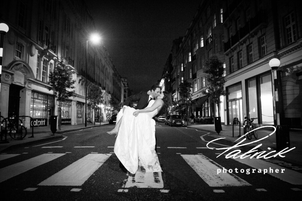 black and white image bride and groom standing on zebra crossing London street call print