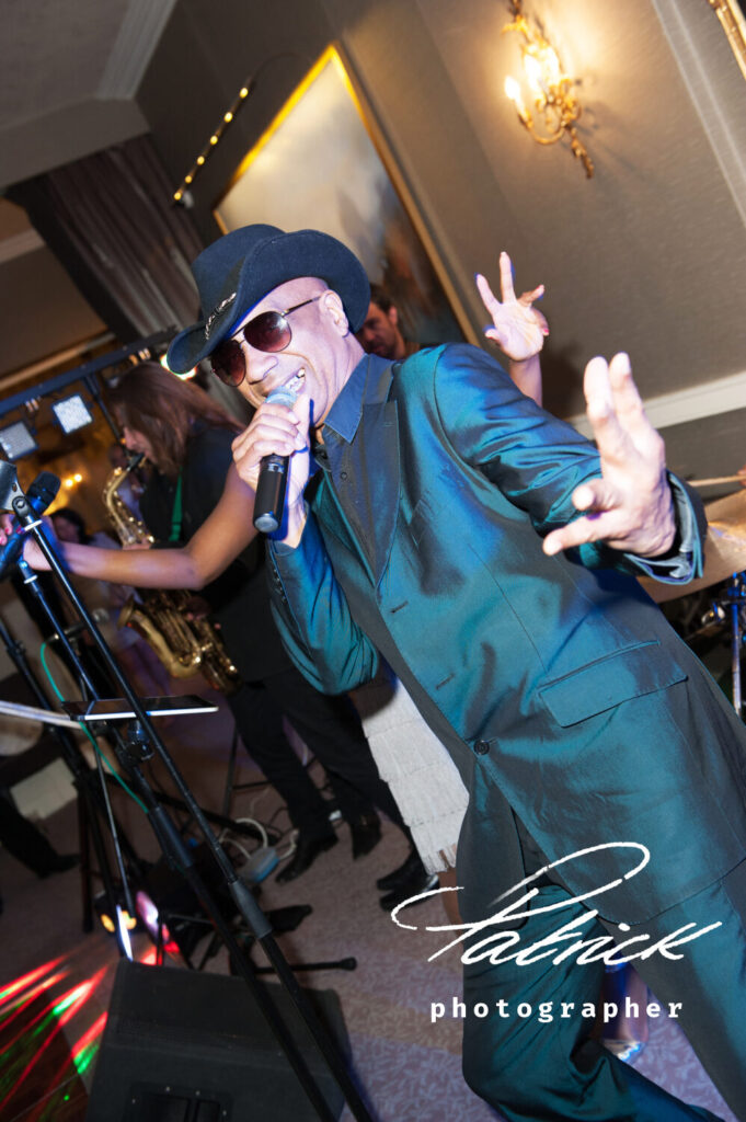 musician male singer pearlescent blue green suit hat sunglasses saxophone microphone st Michaels manor interior