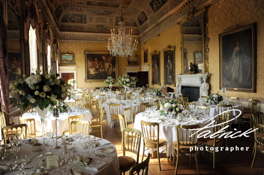 Brocket Hall interior Wedding Breakfast chandeliers grandeur oil paintings lavish table decorations gold chairs painted ceilings