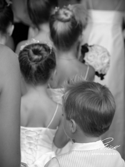 young bridal party lead procession into church black and white