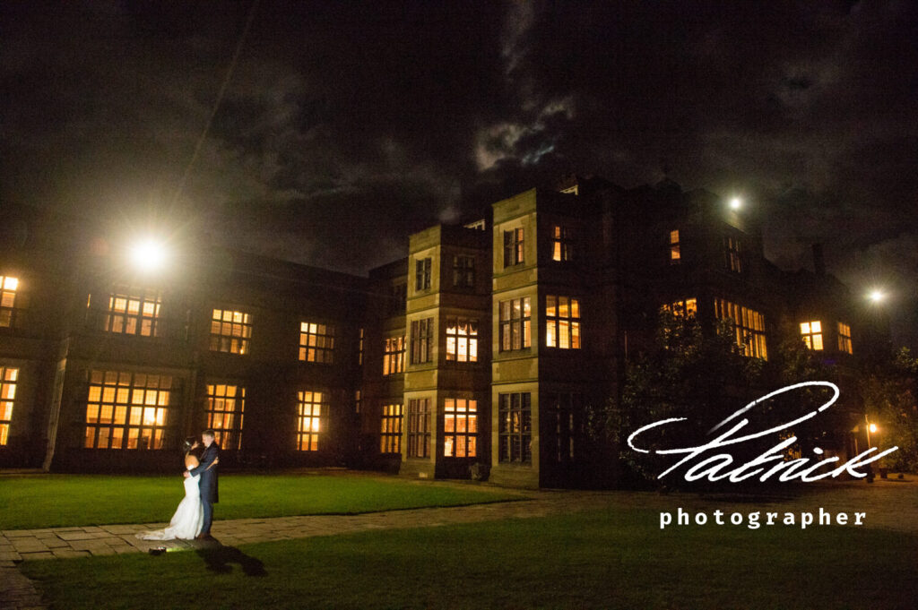 fanhams hall at night, exterior, illuminated, cloudy sky, bride and groom