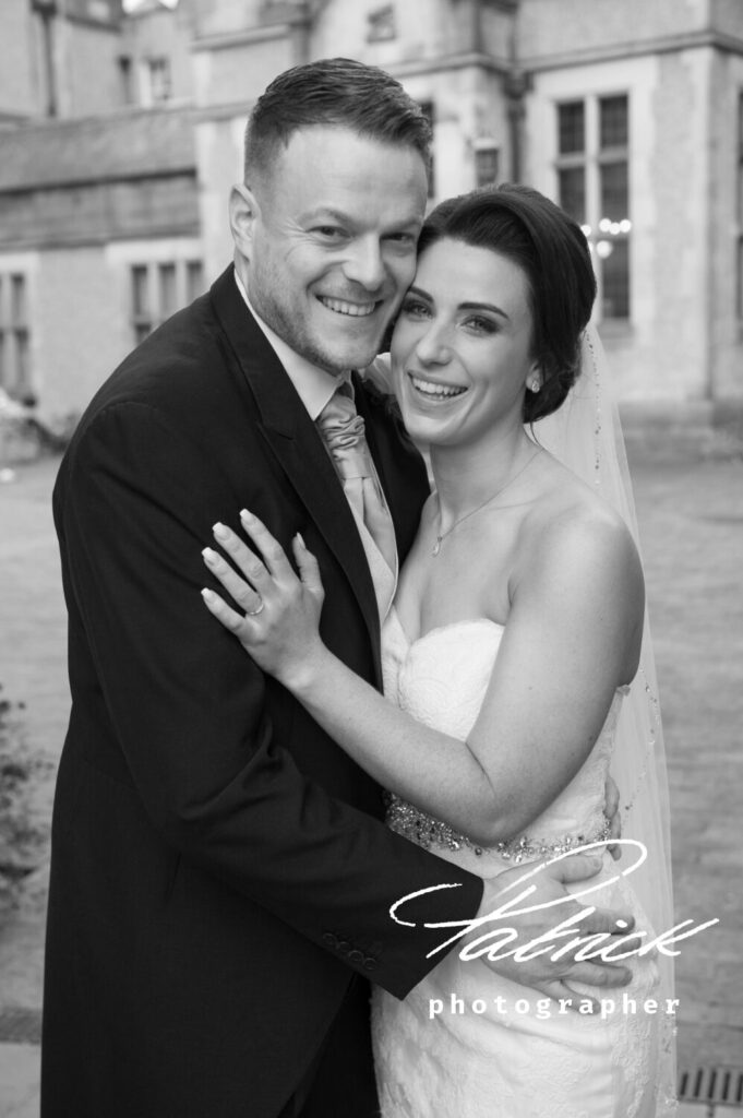 wedding, black and white close up shot, with fanhams hall building in the backgroumd