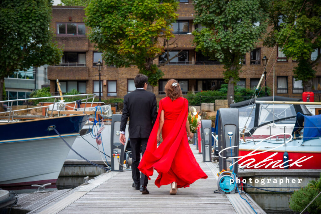 bride and groom, posterior view, walking through st katharine docks London