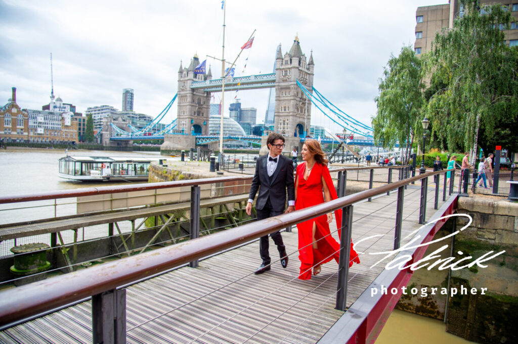 bride (wears red dress) and groom at Tower Bridge London