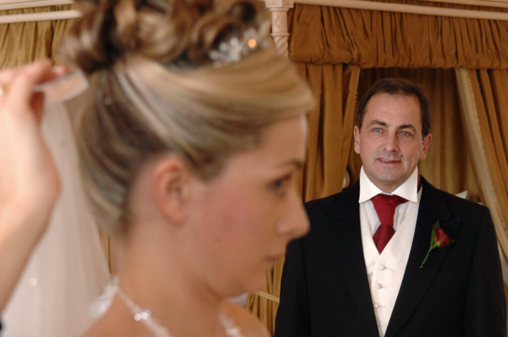 bridal prep hair, father of the bride looking on