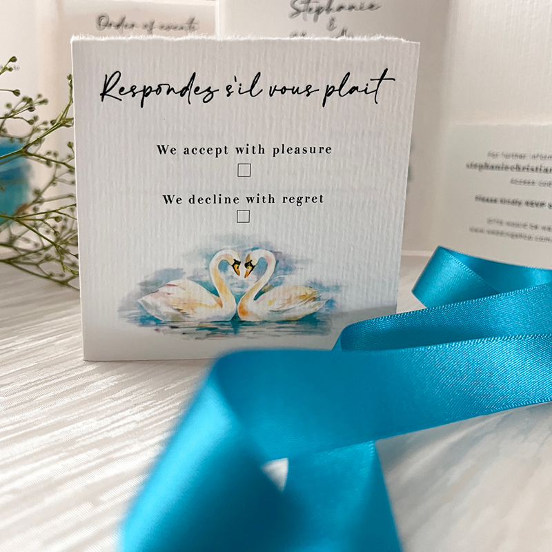 wedding stationery featuring swans blue ribbon