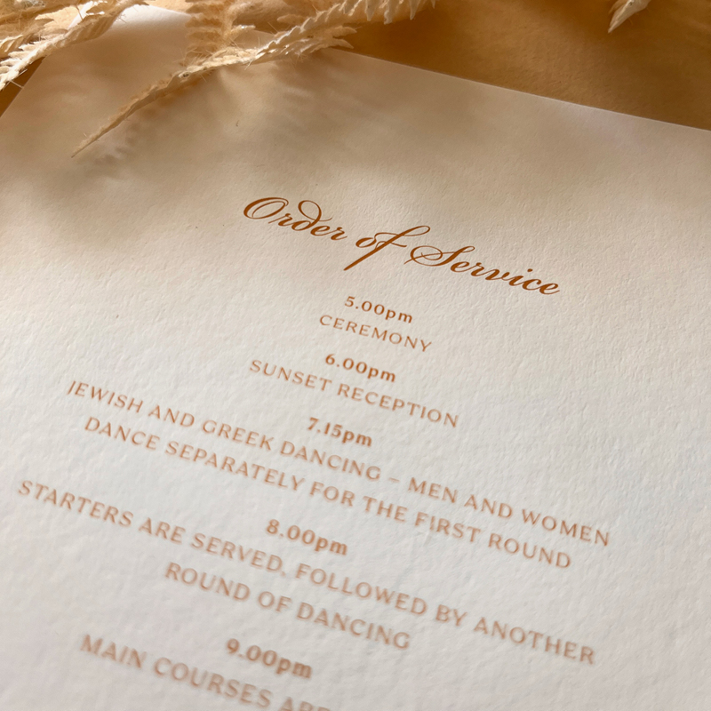 close up of wedding stationery, order of service in focus