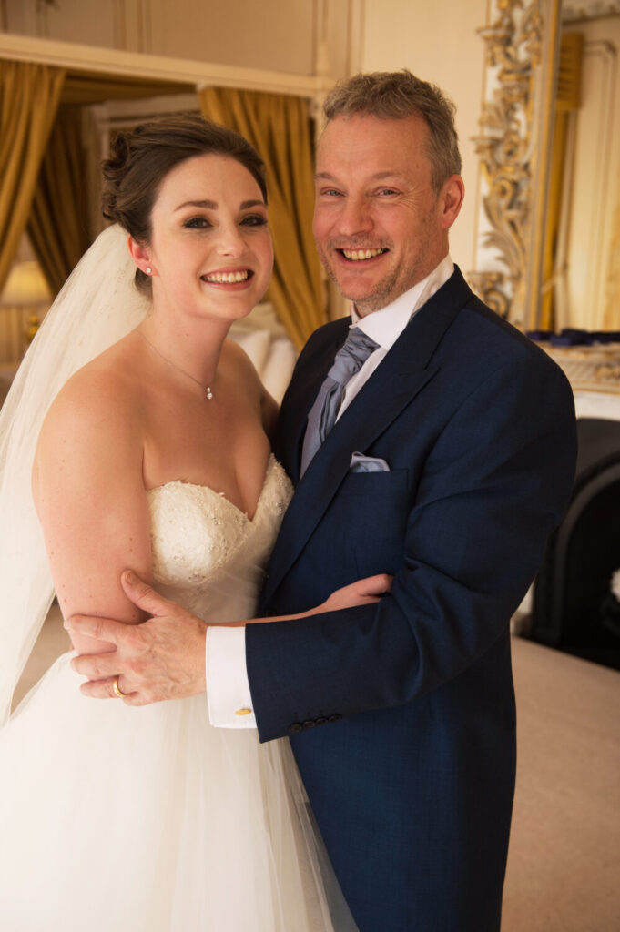 bride and father of the bride close up shot with arms entwined