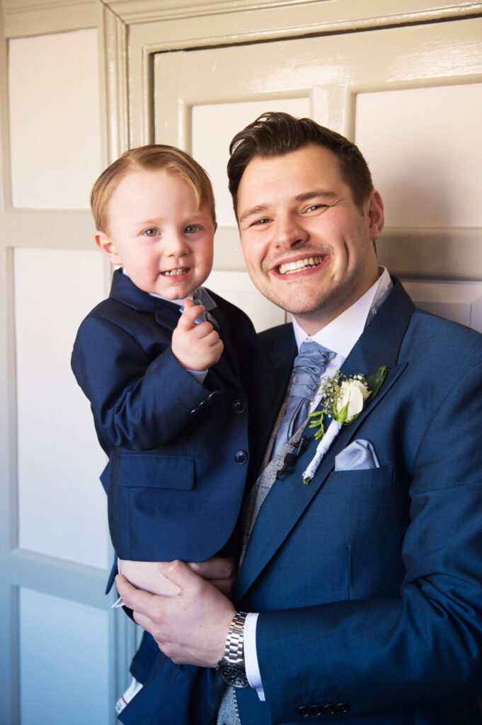 groom and page boy, blue, relaxed, smiling
