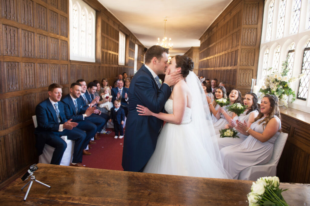 bride and groom kiss at the altar, wedding party clap. ceremony