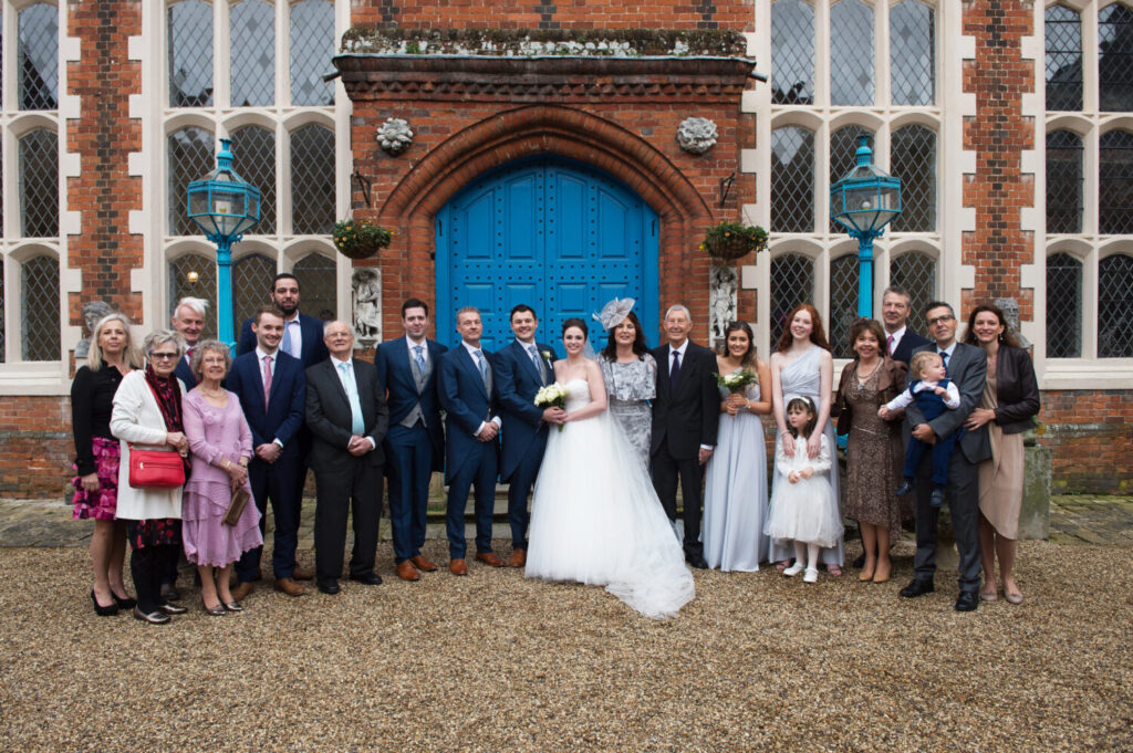 wedding party gather for a formal group shot outside Gosfield Hall