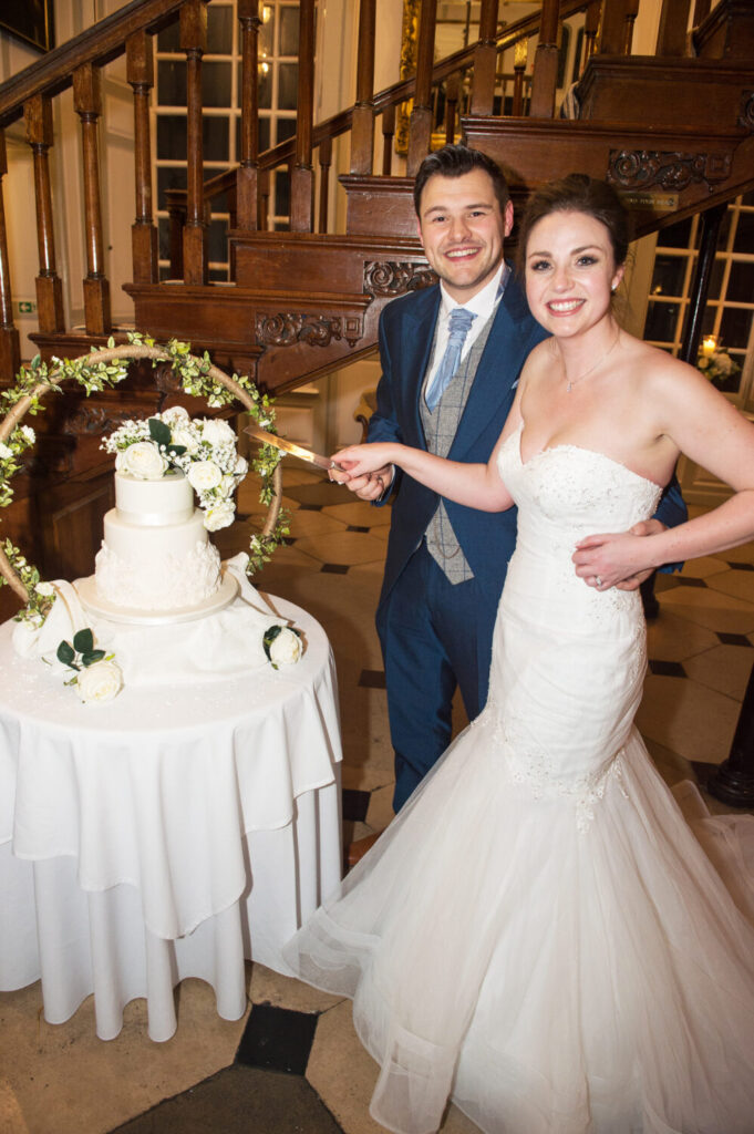 bride and groom cutting of the wedding cake